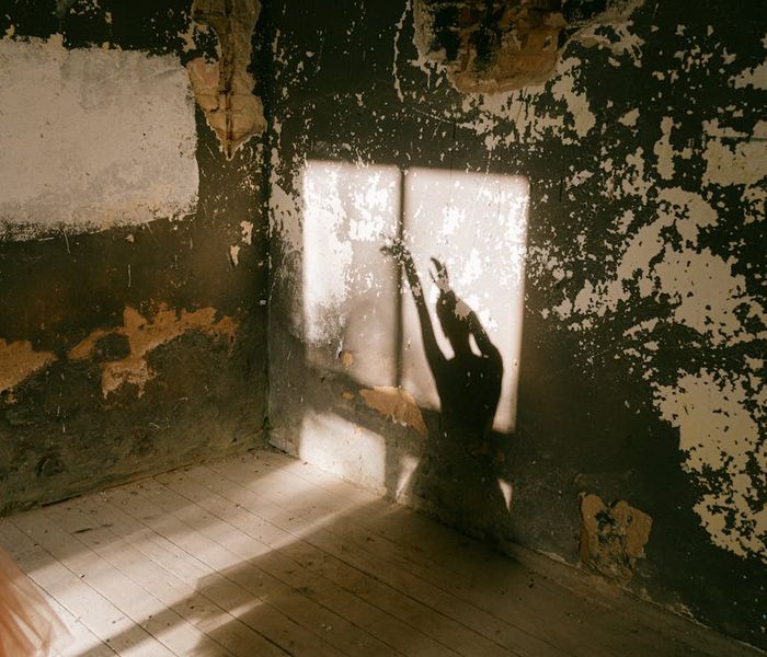 Person stretching in a bright, sunlit room, feeling energized.